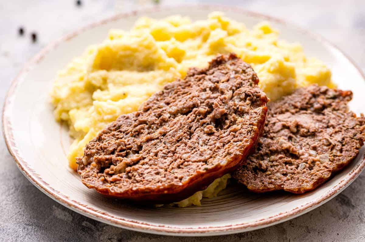 Plate with two slices of meatloaf and mashed potatoes