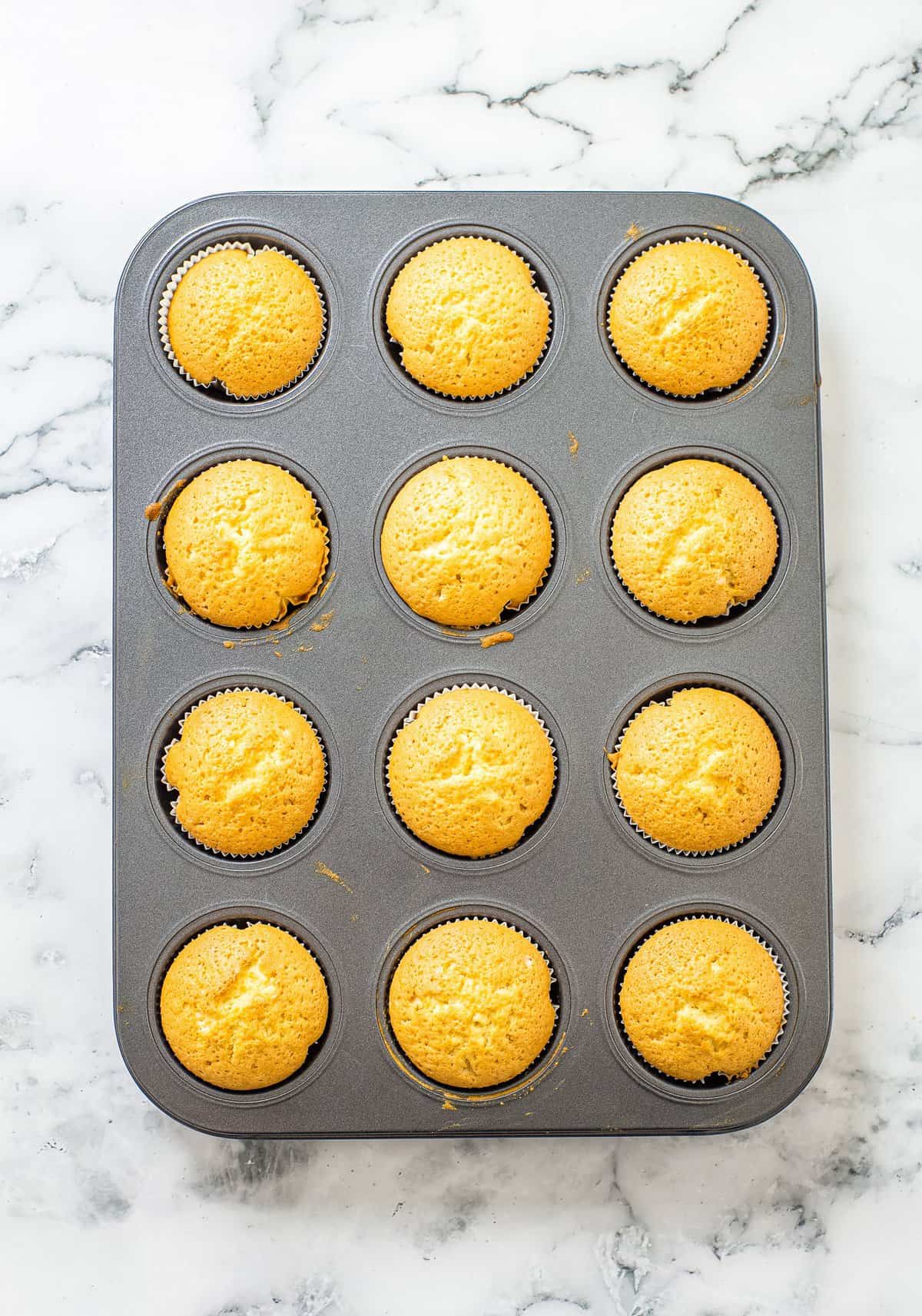 Overhead image of lemon muffins in tin