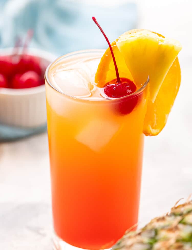 Glass of Malibu Sunset with maraschino cherry and fruit garnish