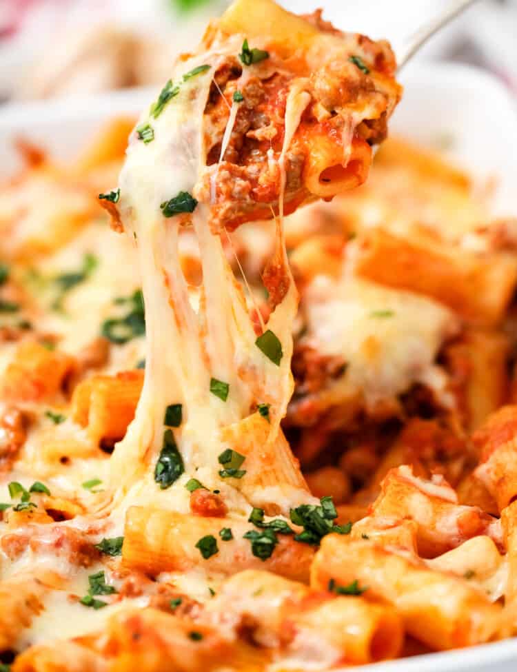 Scooping Rigatoni out of casserole dish with spoon