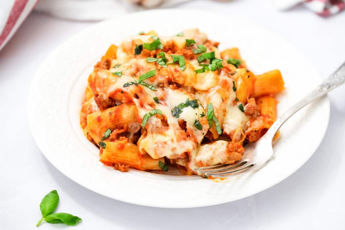 White plate with baked rigatoni on it