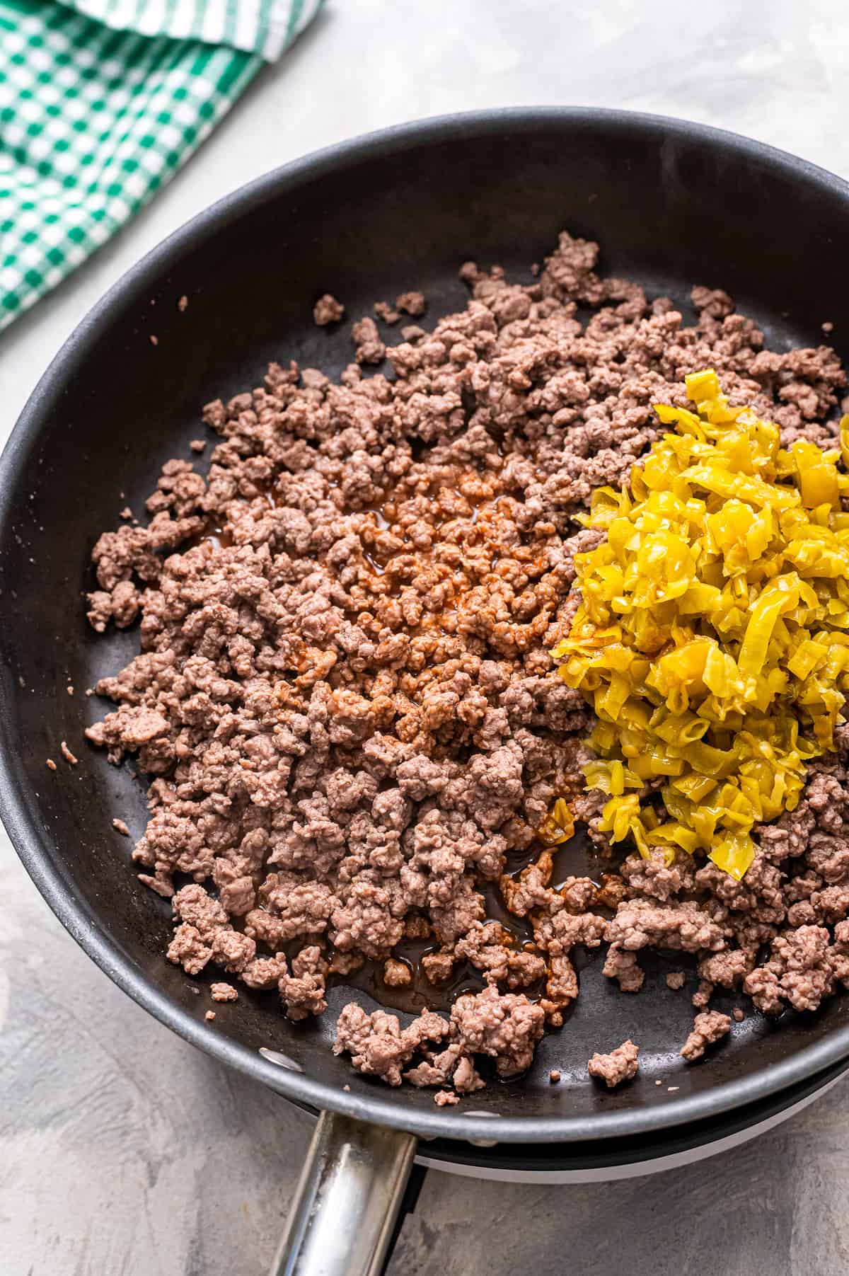 Skillet with ground beef and seasonings in it