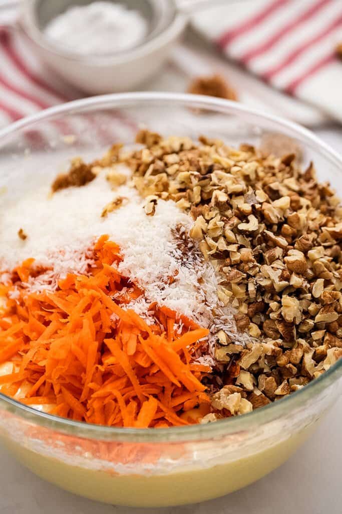 Ingredients to make carrot cake bars in glass bowl