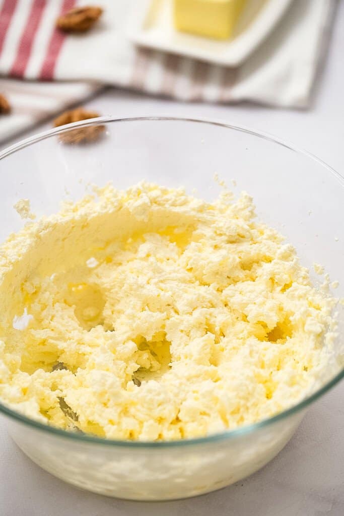 Cream cheese frosting mixed in glass bowl