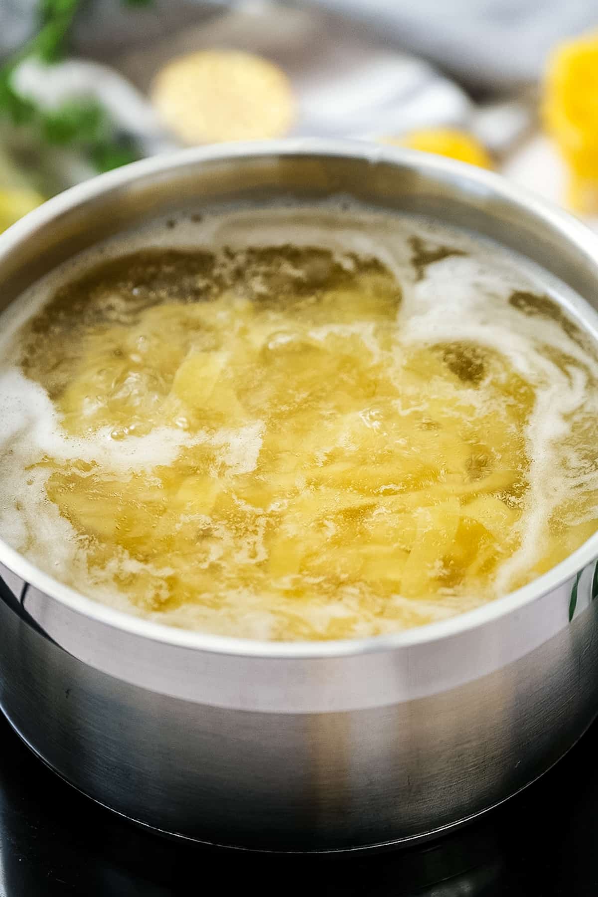 Saucepan pan with boiling water and fettucine noodles