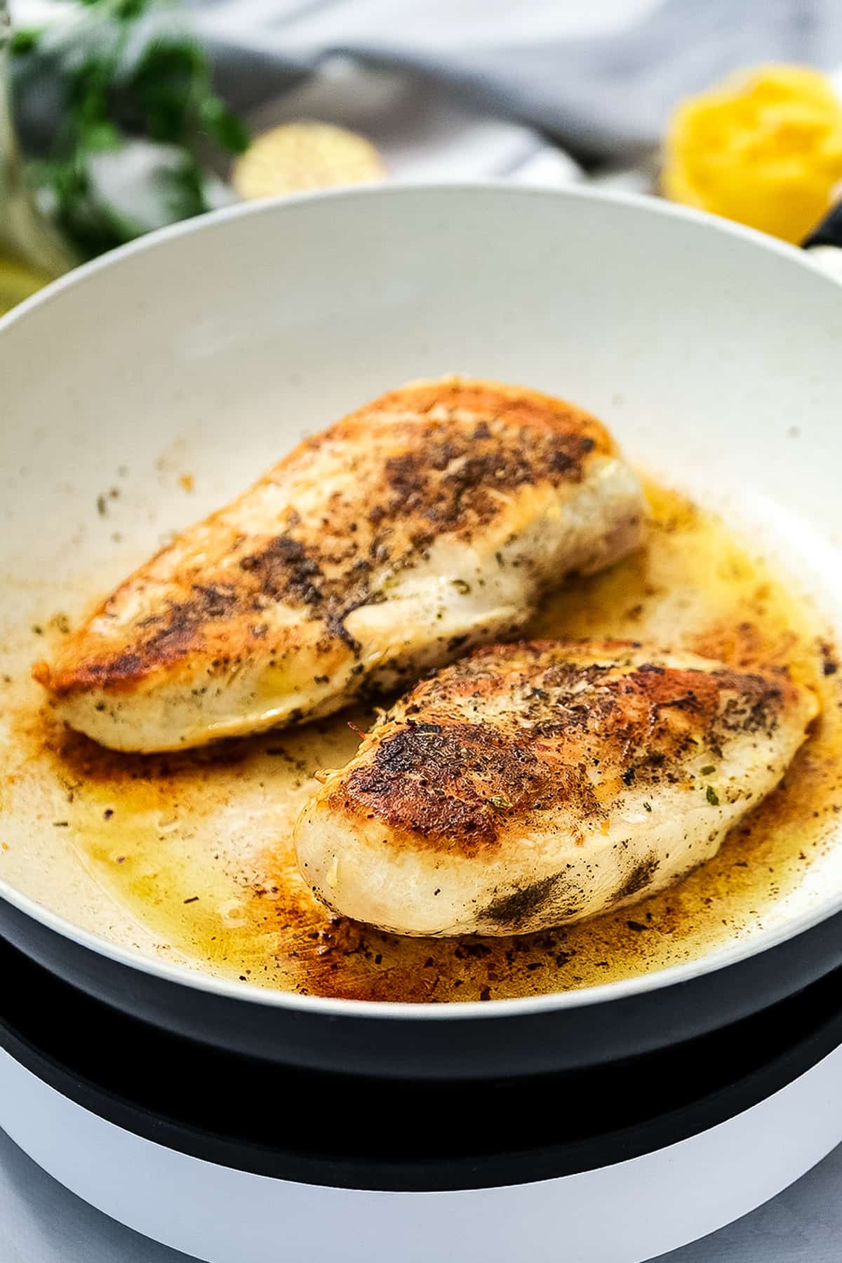 Skillet with pan fried chicekn breasts