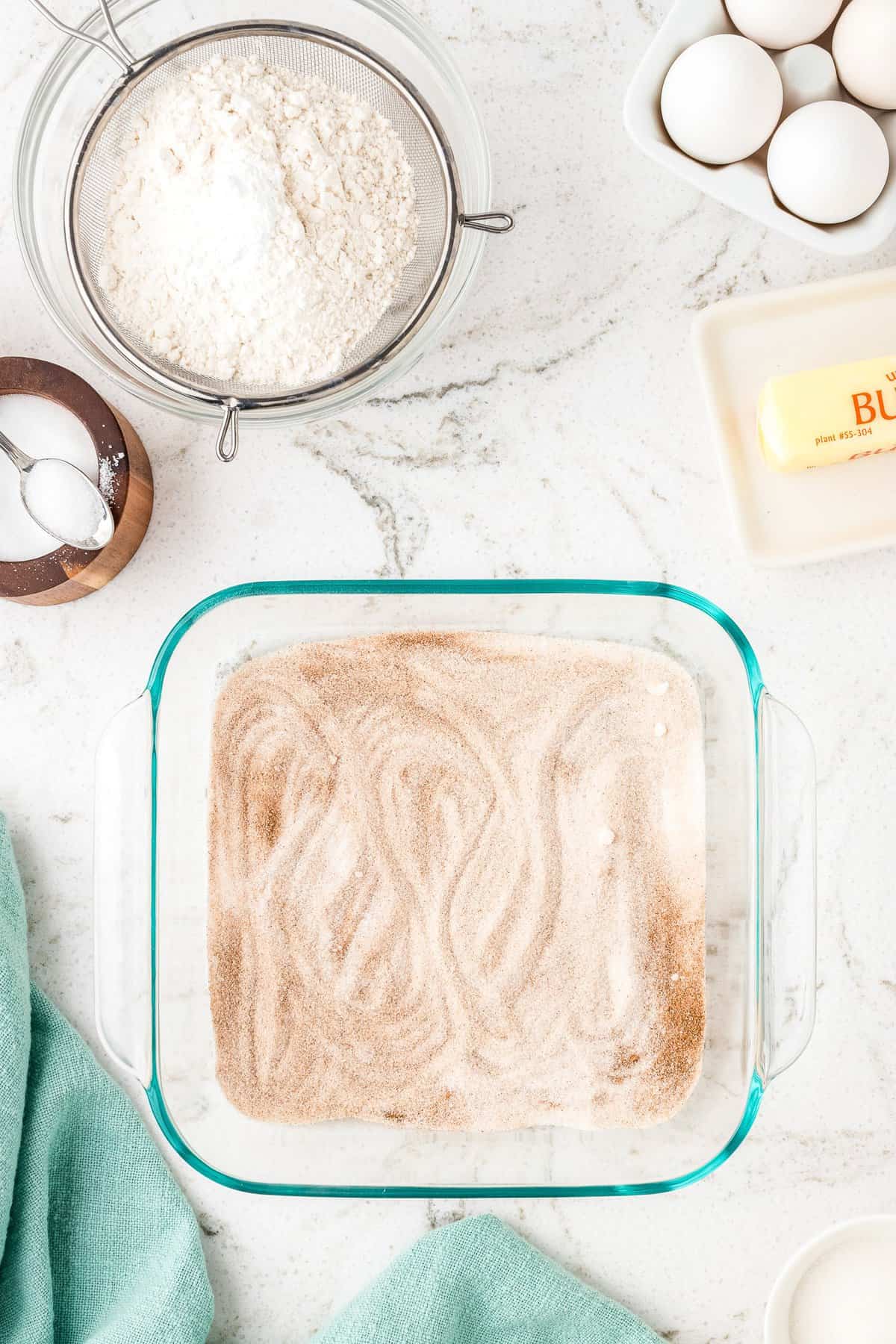 Overhead image of cinnamon sugar in glass pan