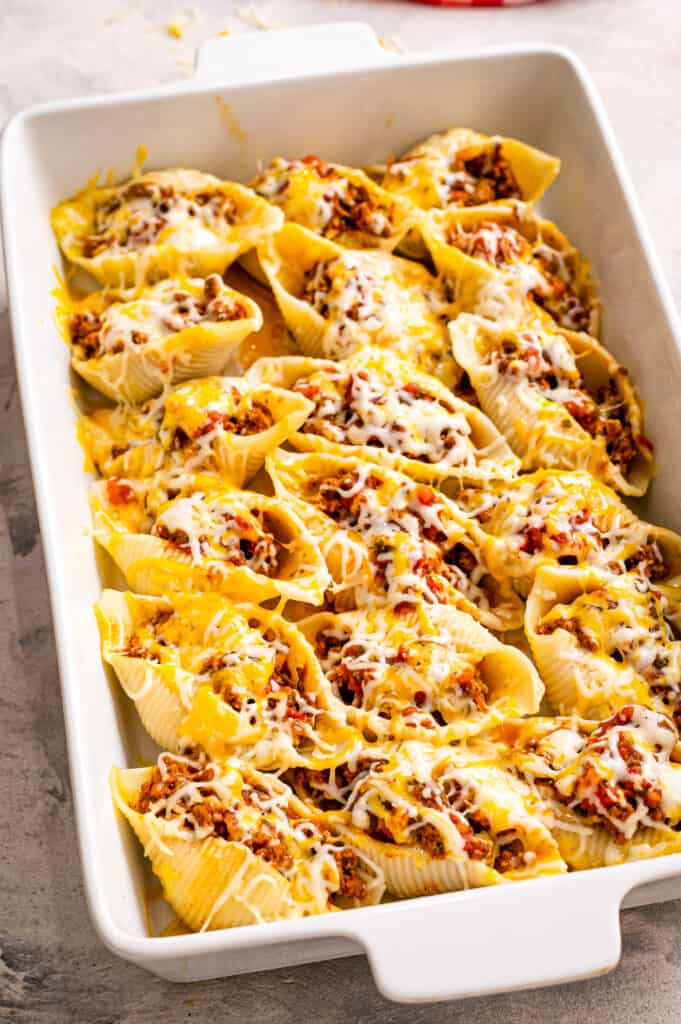 White casserole dish with stuffed taco shells after baking