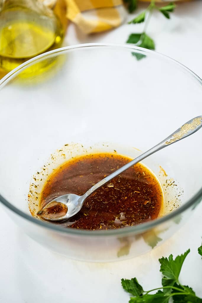 Glass bowl with oil and seasonings mixed together