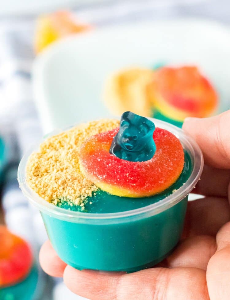 Hand holding a beach themed pudding shot