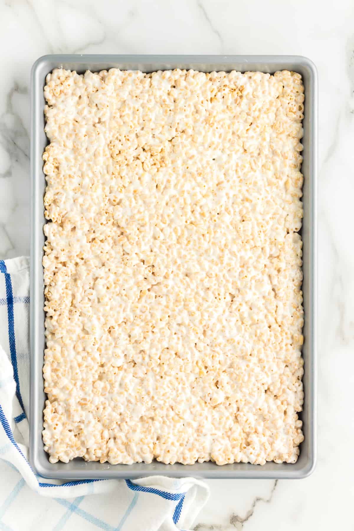 First layer of rice krispie treats in pan