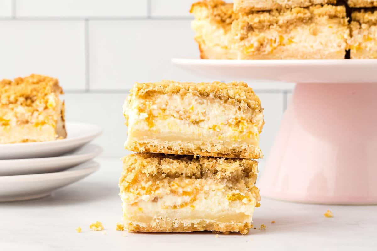 Crumble Peach Cheesecake Bars cut and stacked