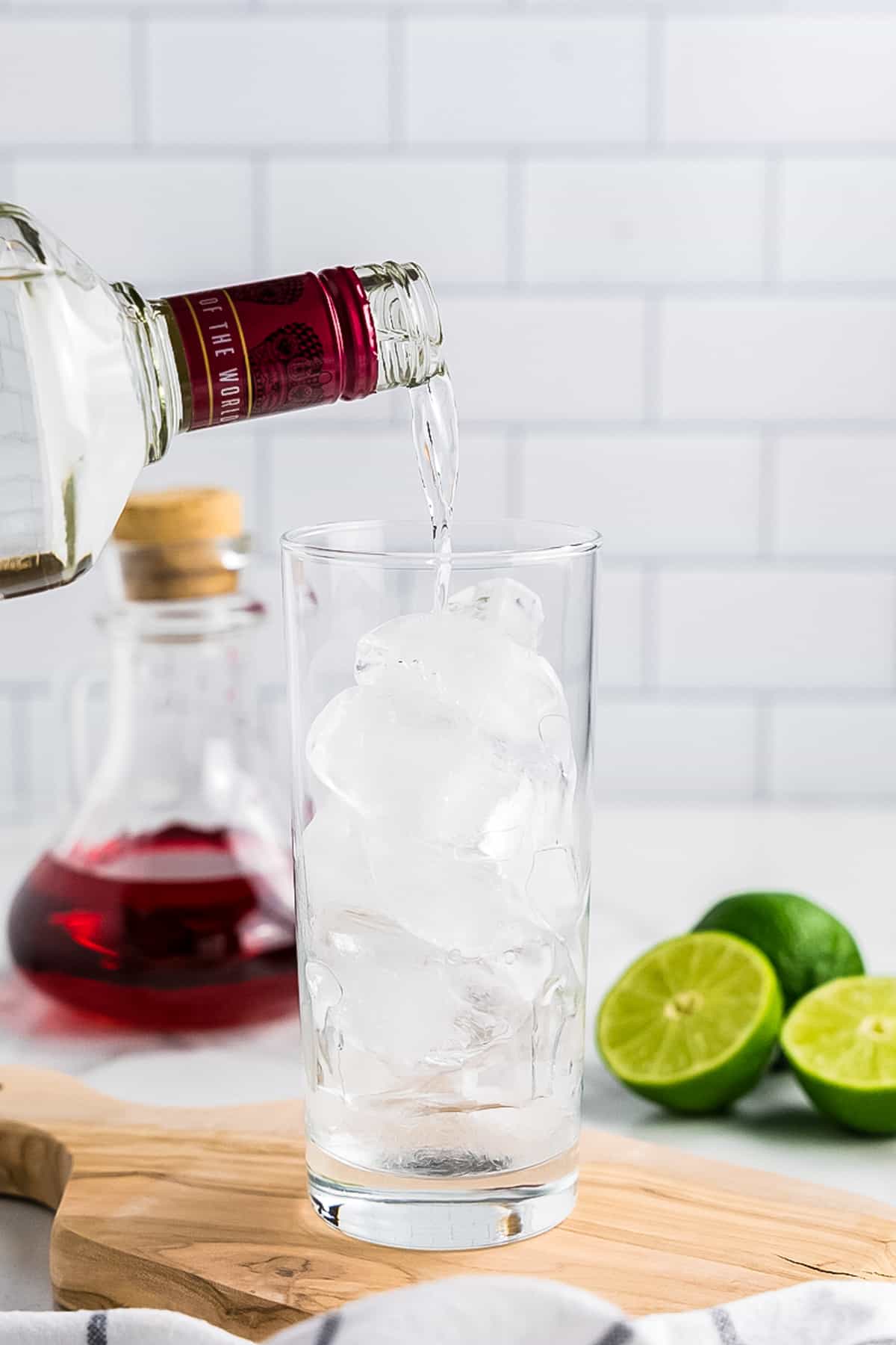 Pouring cherry vodka into cocktail glass