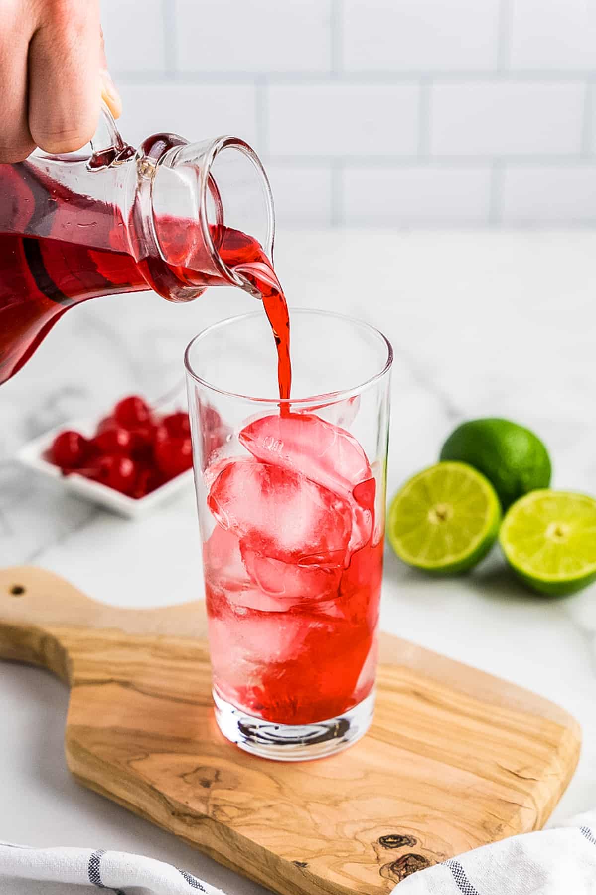 Pouring Grenadine into cocktail glass