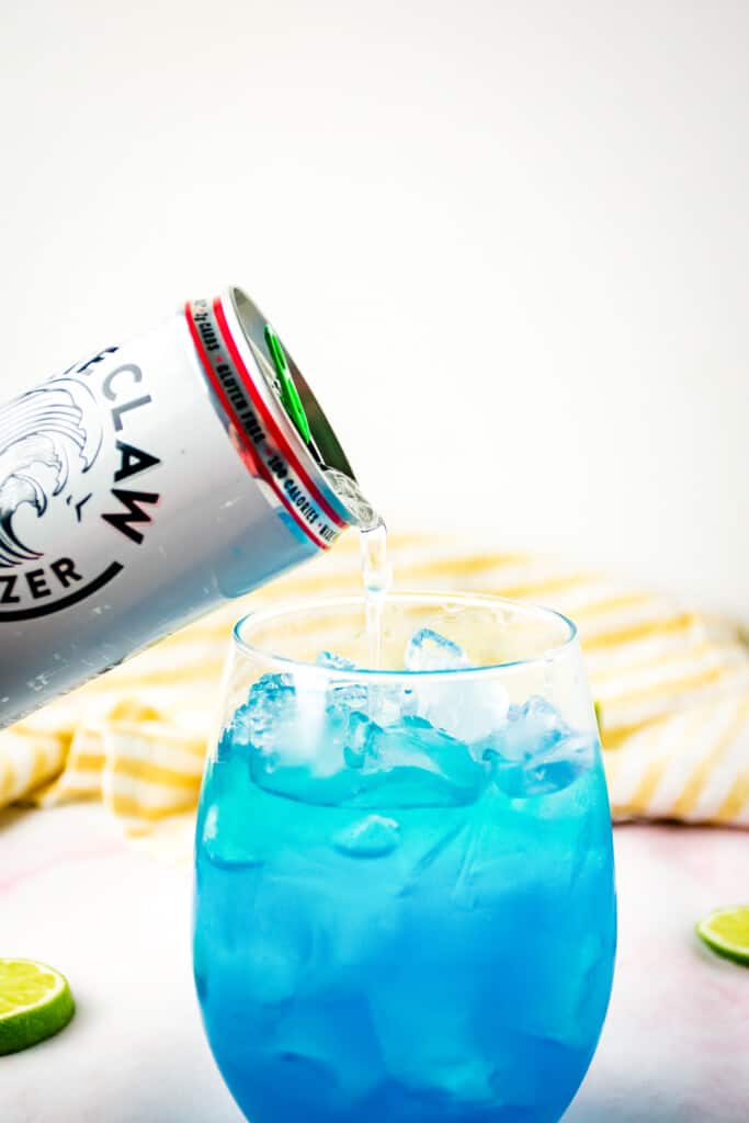 Pouring Watermelon Seltzer into cocktail