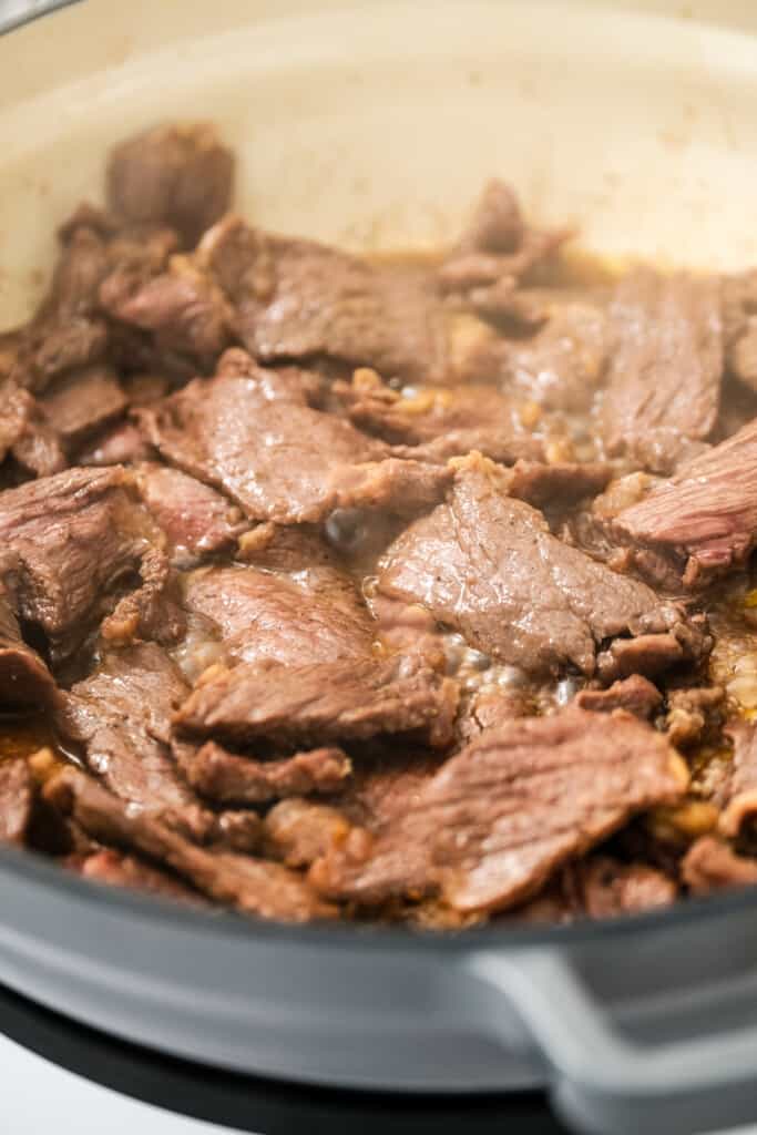 Skillet with cooked steak pieces