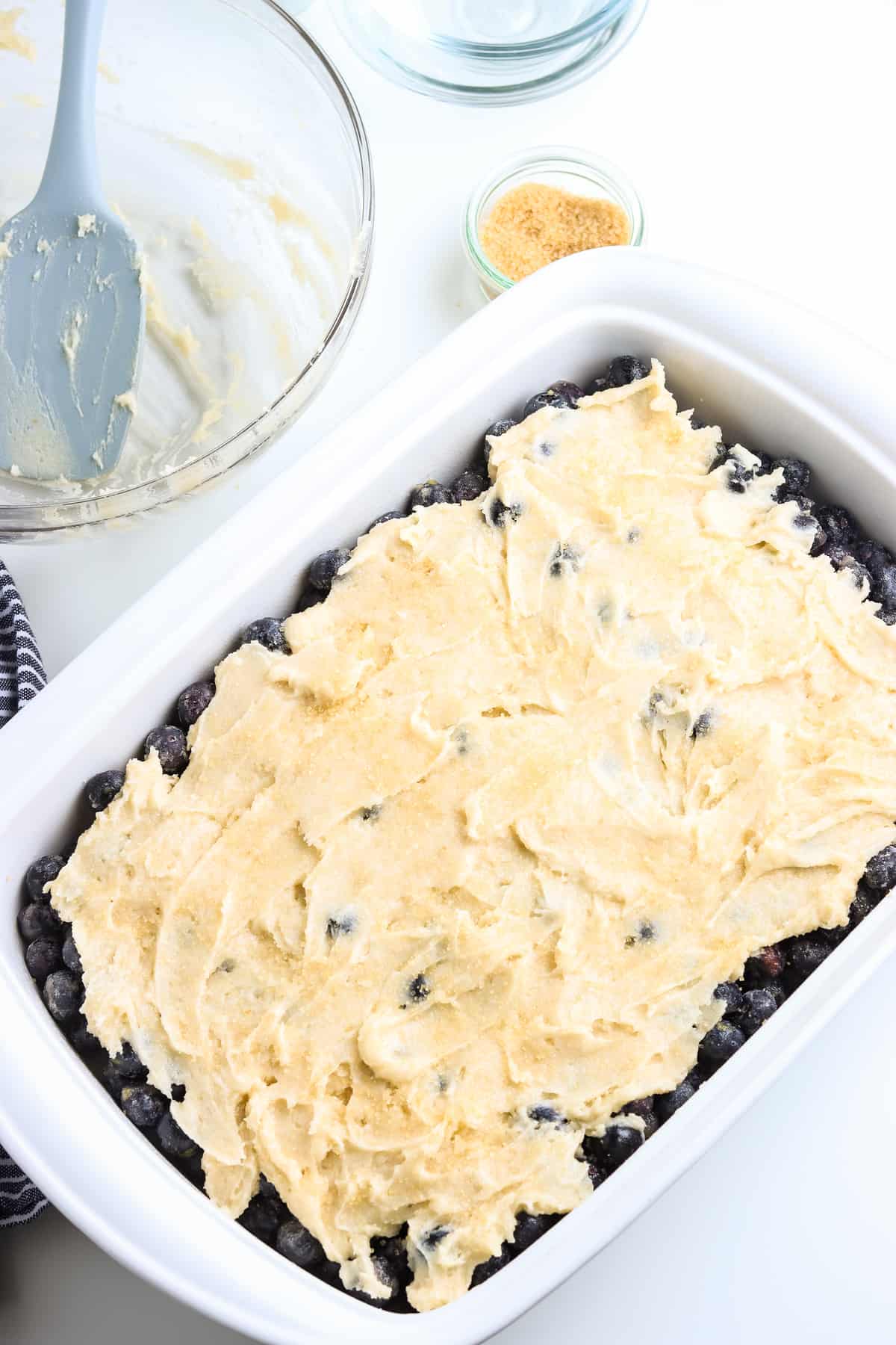 Overhead image of blueberry cobbler in pan before baking.