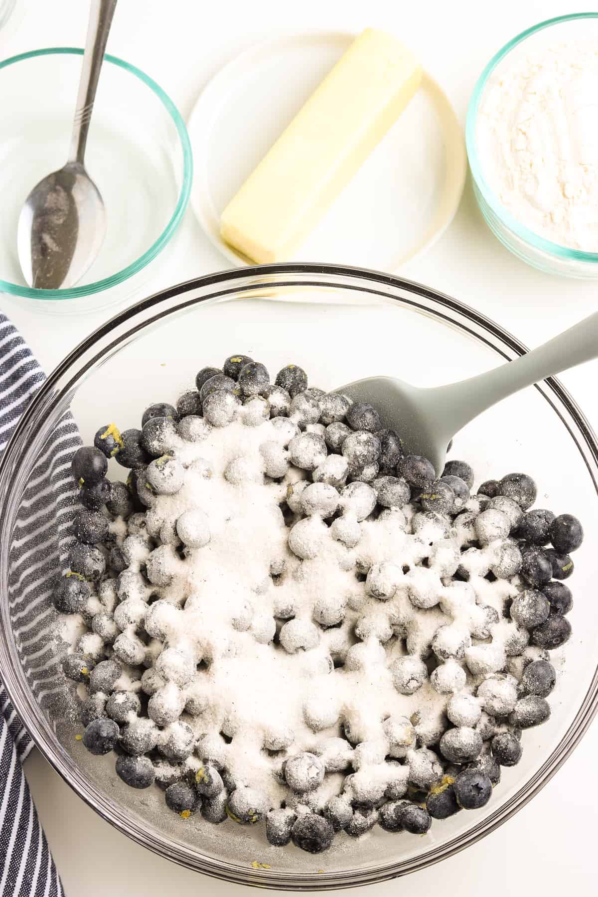 Blueberries in bowl with flour.