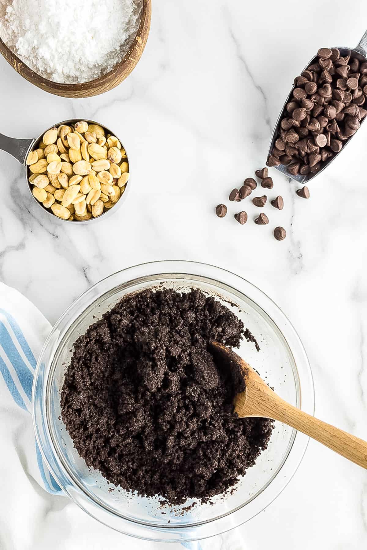 Glass bowl with oreo crumbs mixed with butter