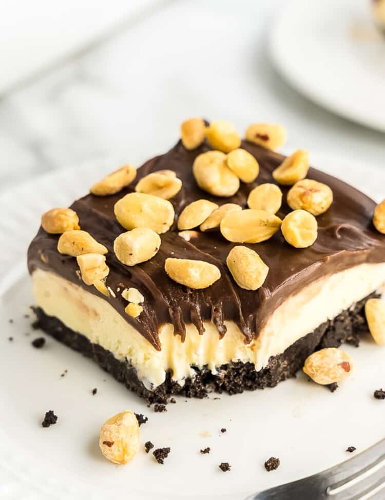 Slice of buster bar dessert on white plate