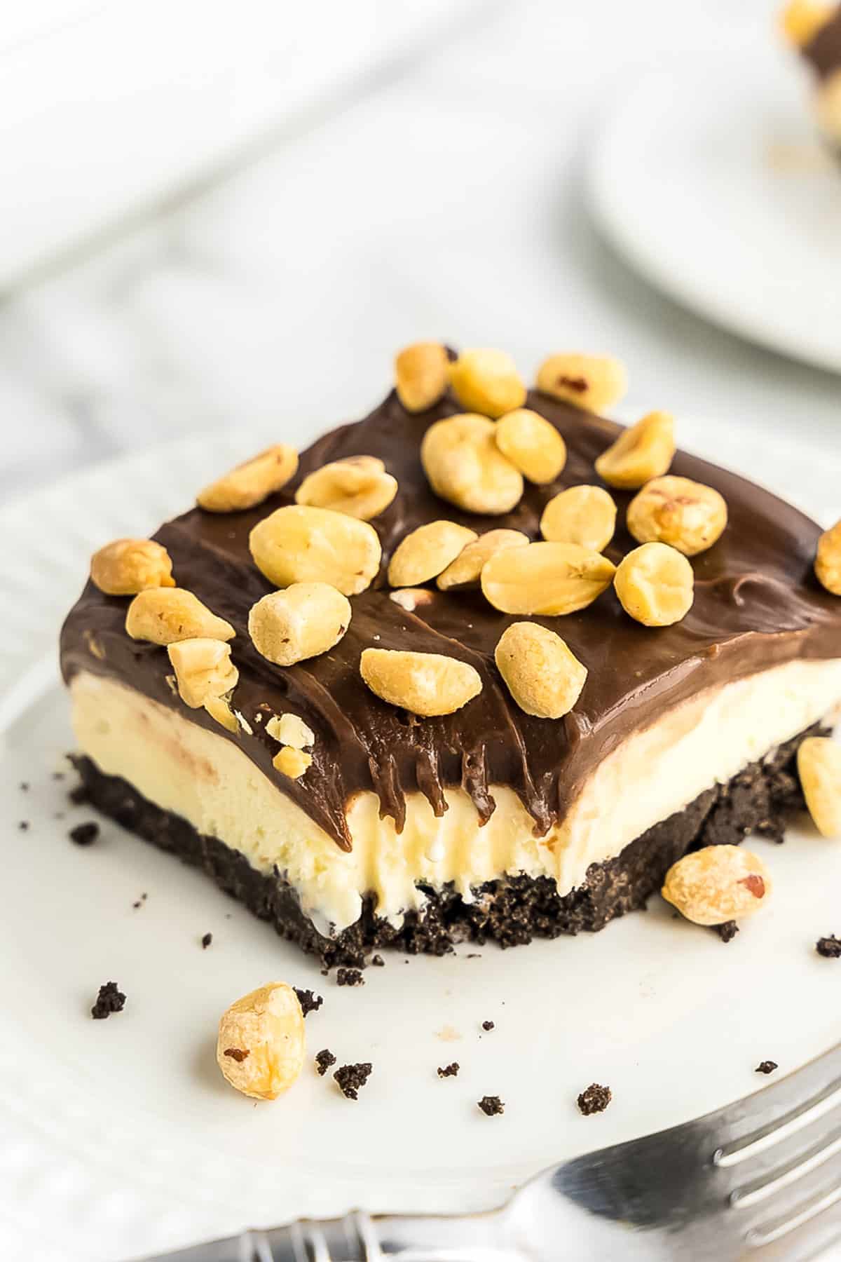 Slice of buster bar dessert on white plate