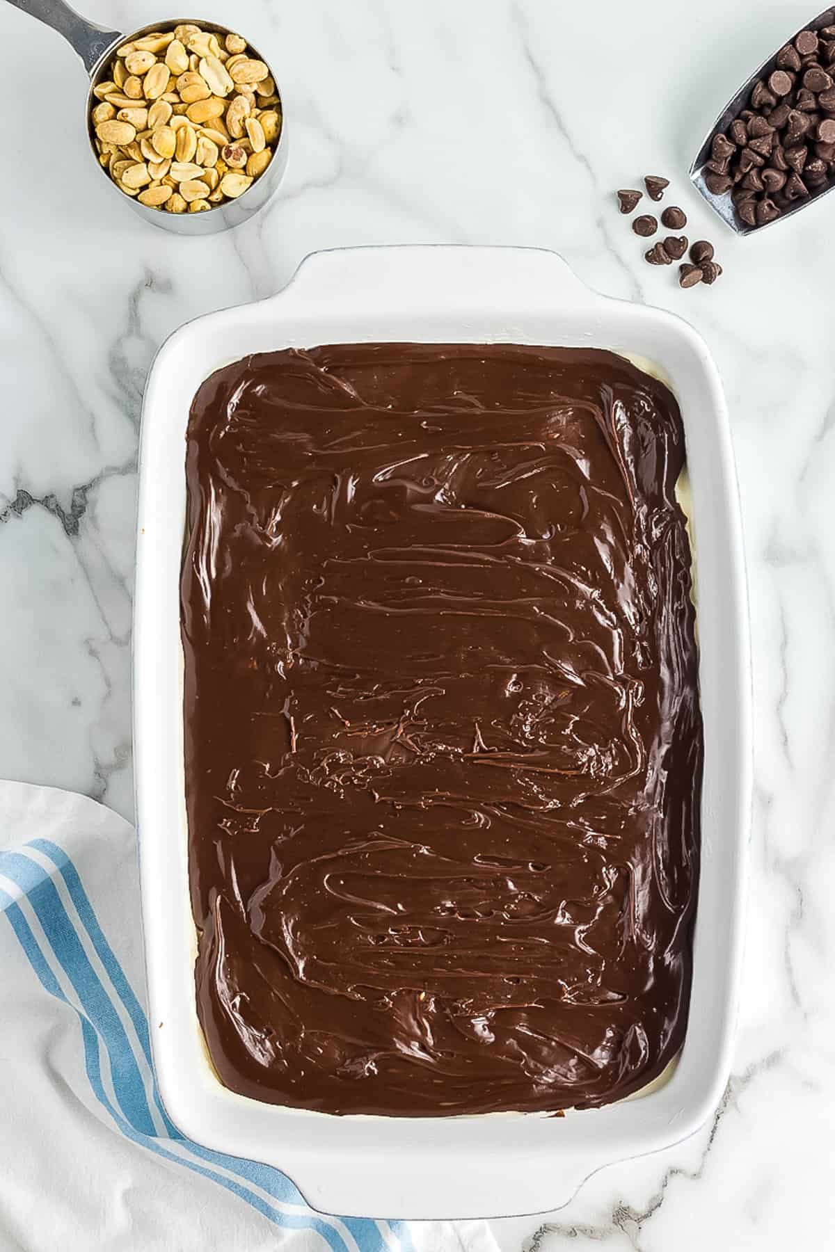 White baking dish with homemade fudge sauce layer