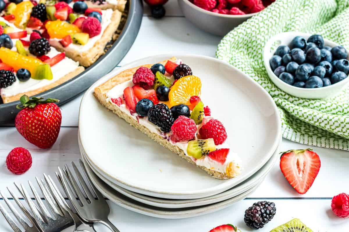 Slice of fruit pizza on white plate