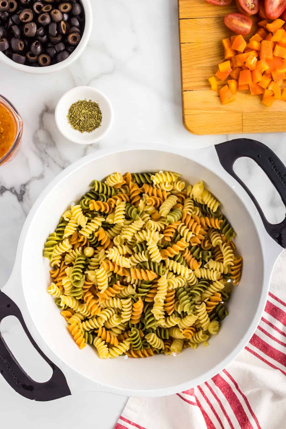 Cooked tricolor rotini pasta in colander