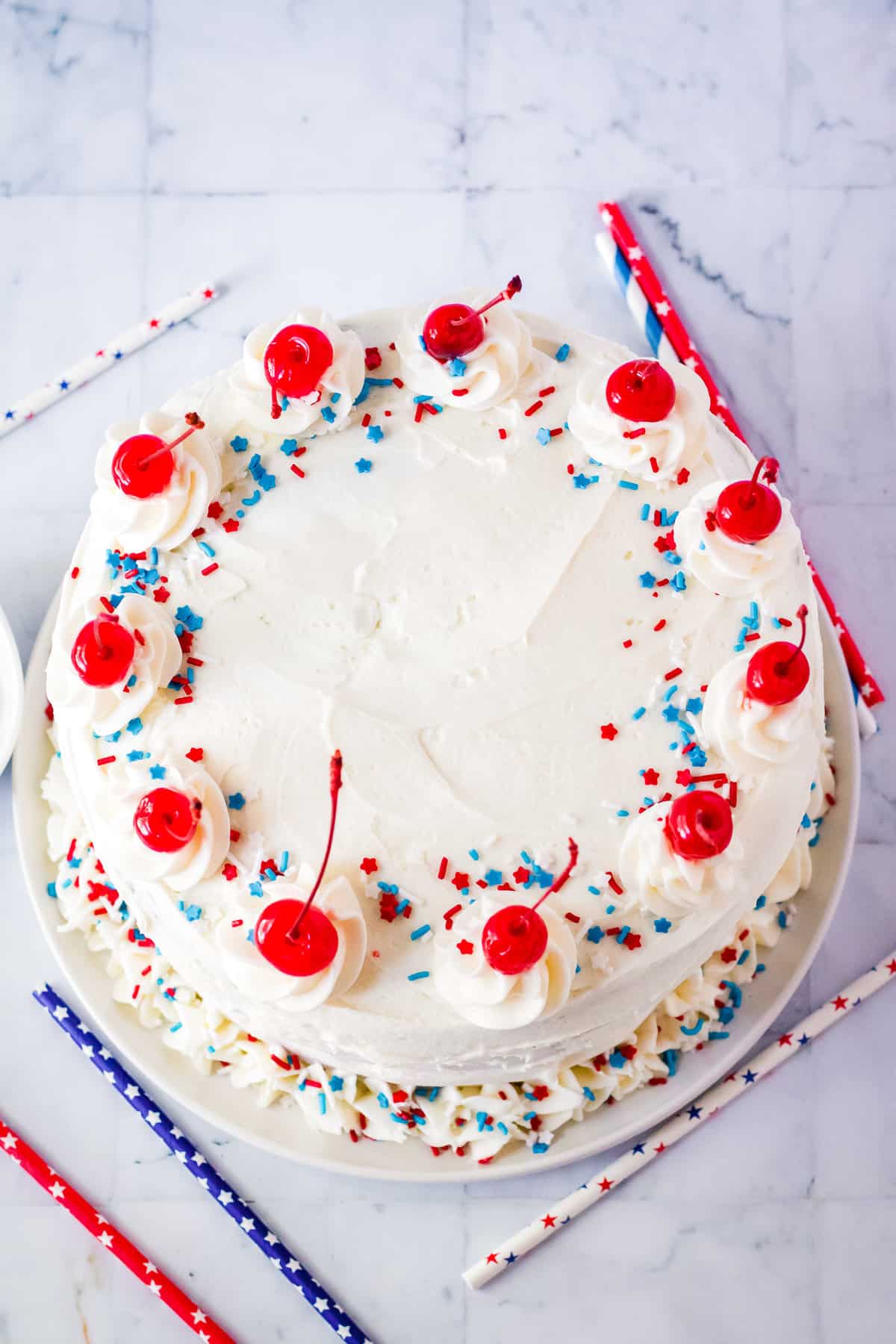 Overhead image of vanilla cake with cherries