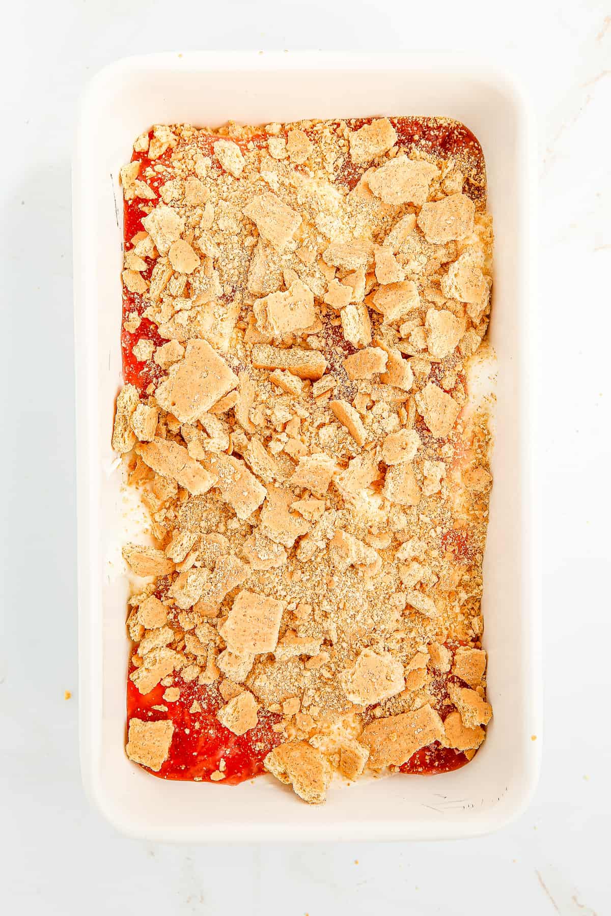 Graham crackers on top of strawberry cheesecake ice cream