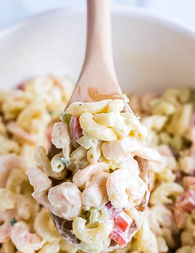 Bowl with Shrimp Pasta Salad and wooden spoons