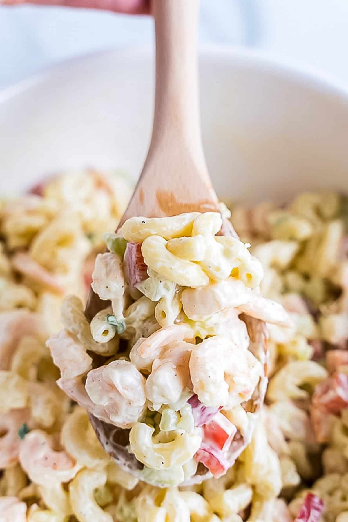 Bowl with Shrimp Pasta Salad and wooden spoons