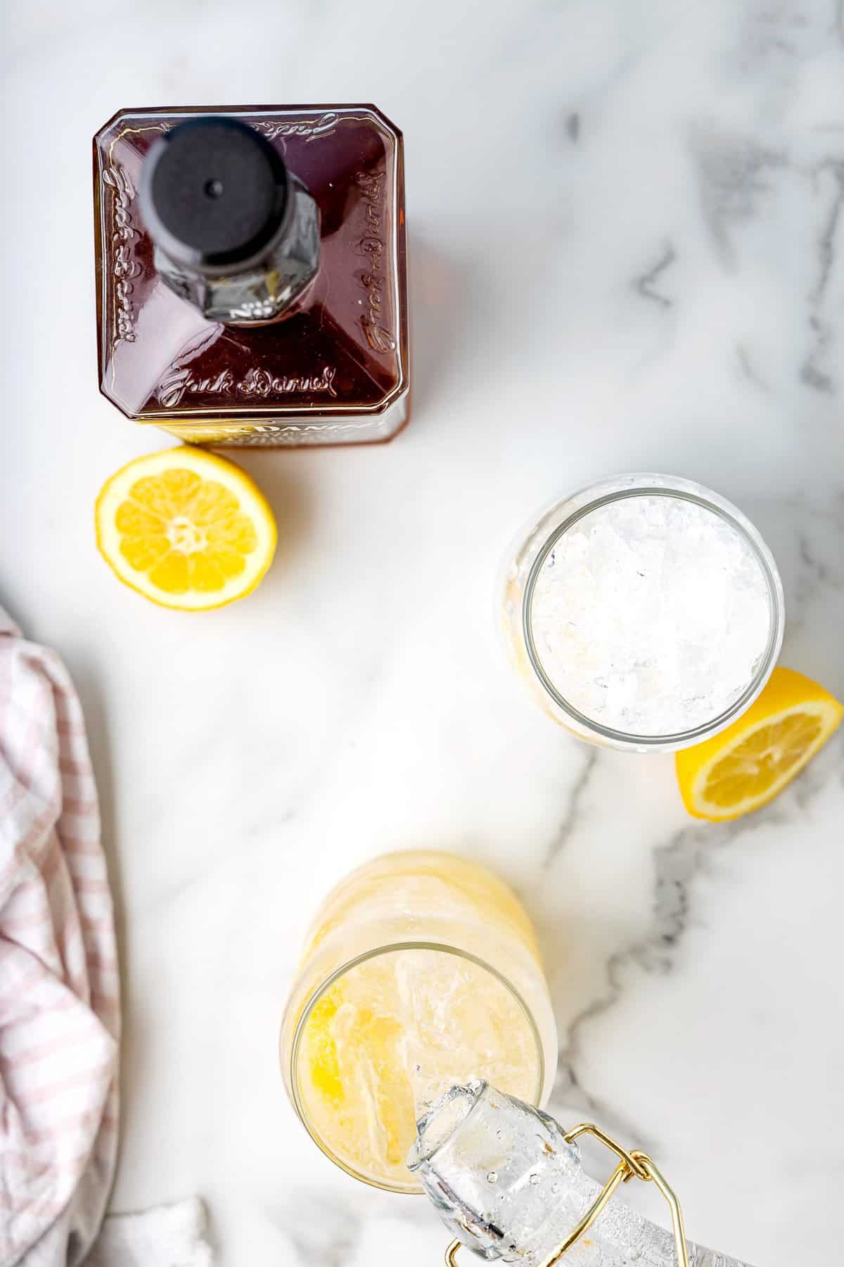 Pouring sparkling water in lemonade