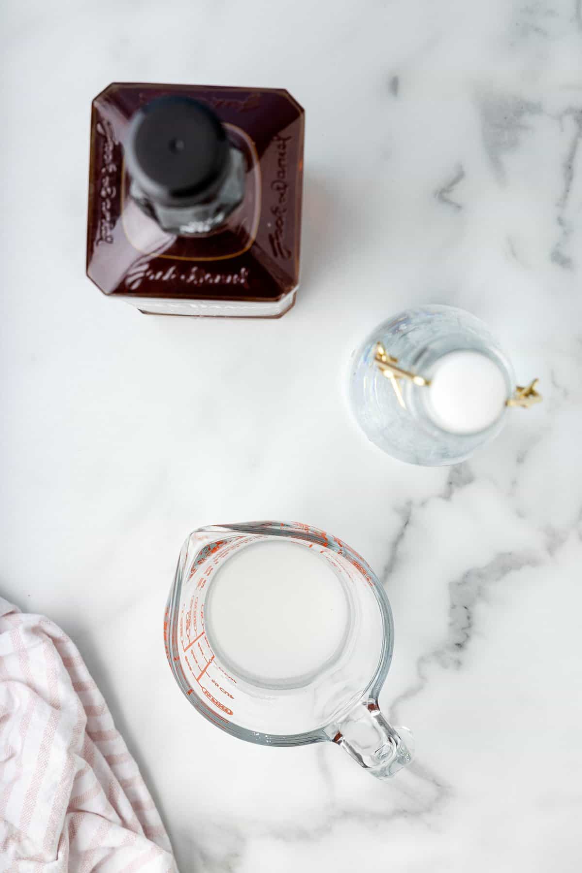 Water and sugar in glass measuring cup