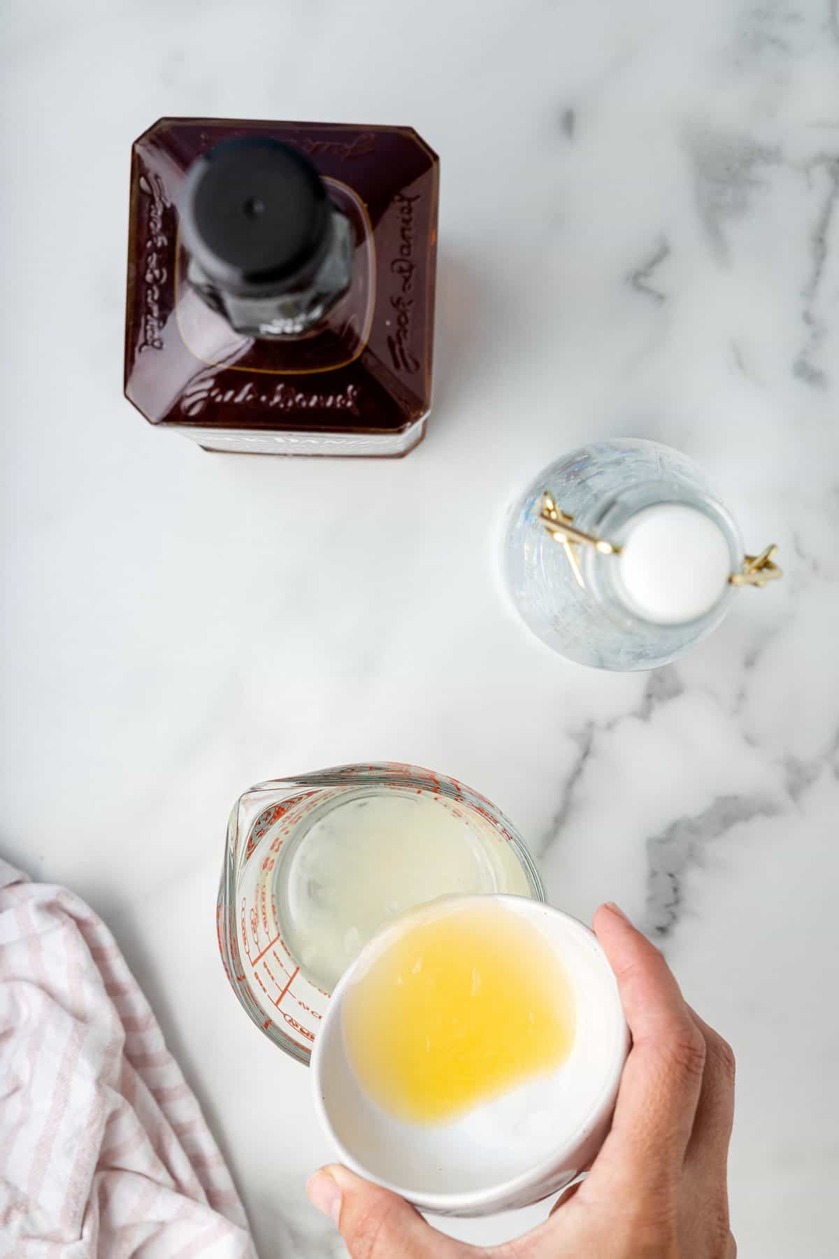 Pouring lemon juice into simple syrup