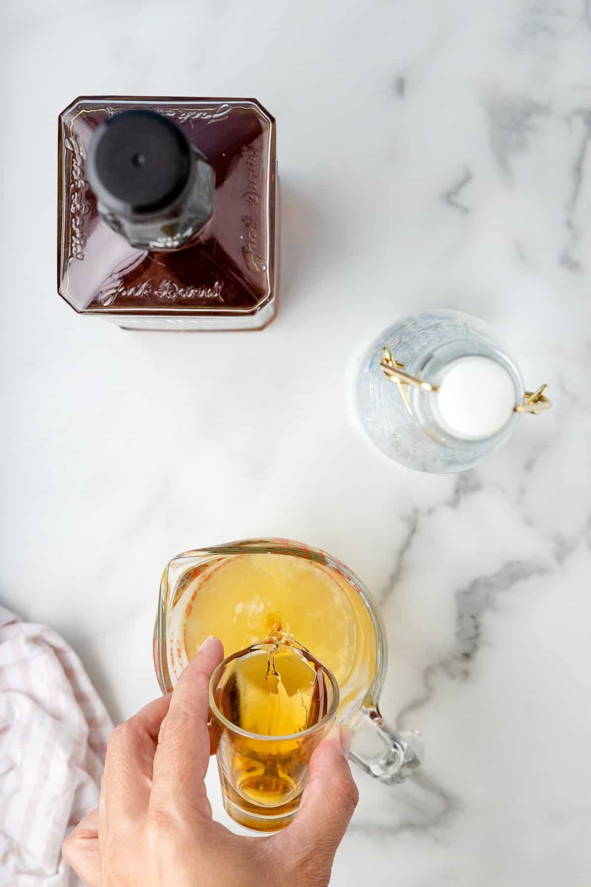 Pouring whiskey into lemonade