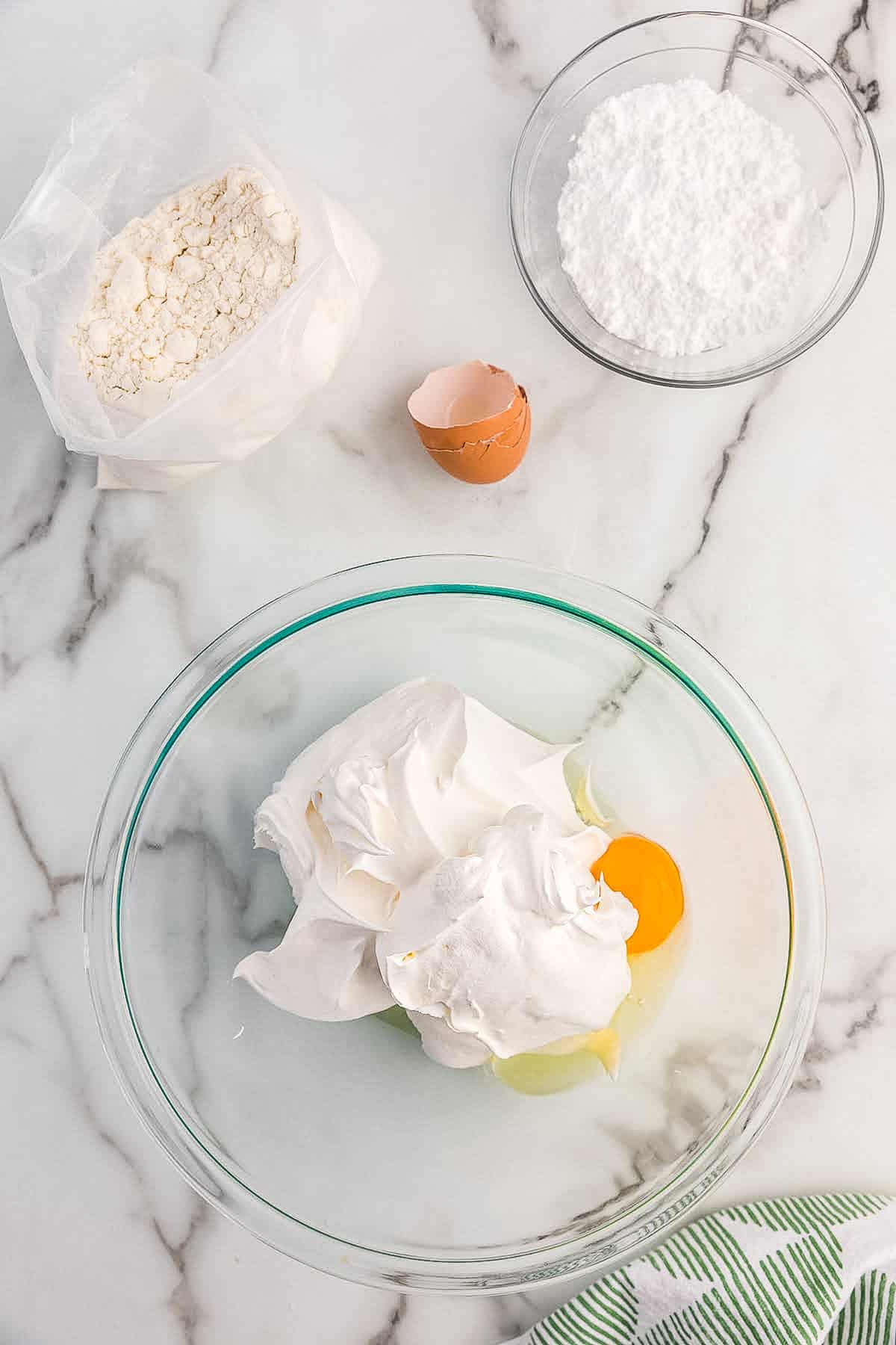 Glass bowl with ingredients before mixing for cool whip cookies