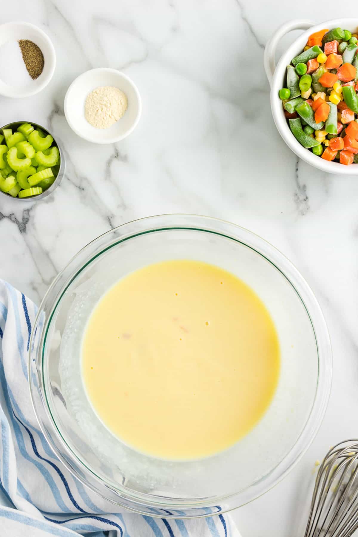 Glass bowl with whisk cream of chicken soup and milk