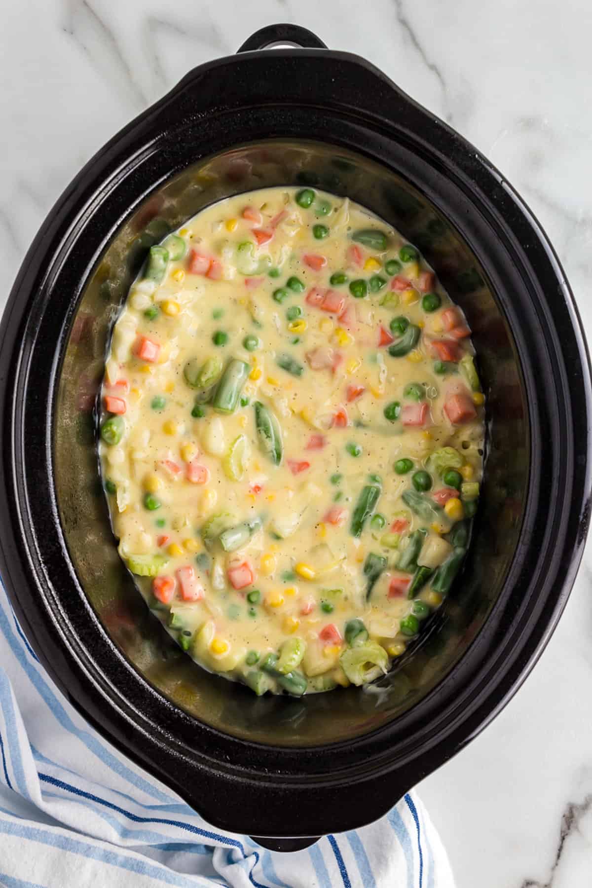 Slow cooker with chicken pot pie in it