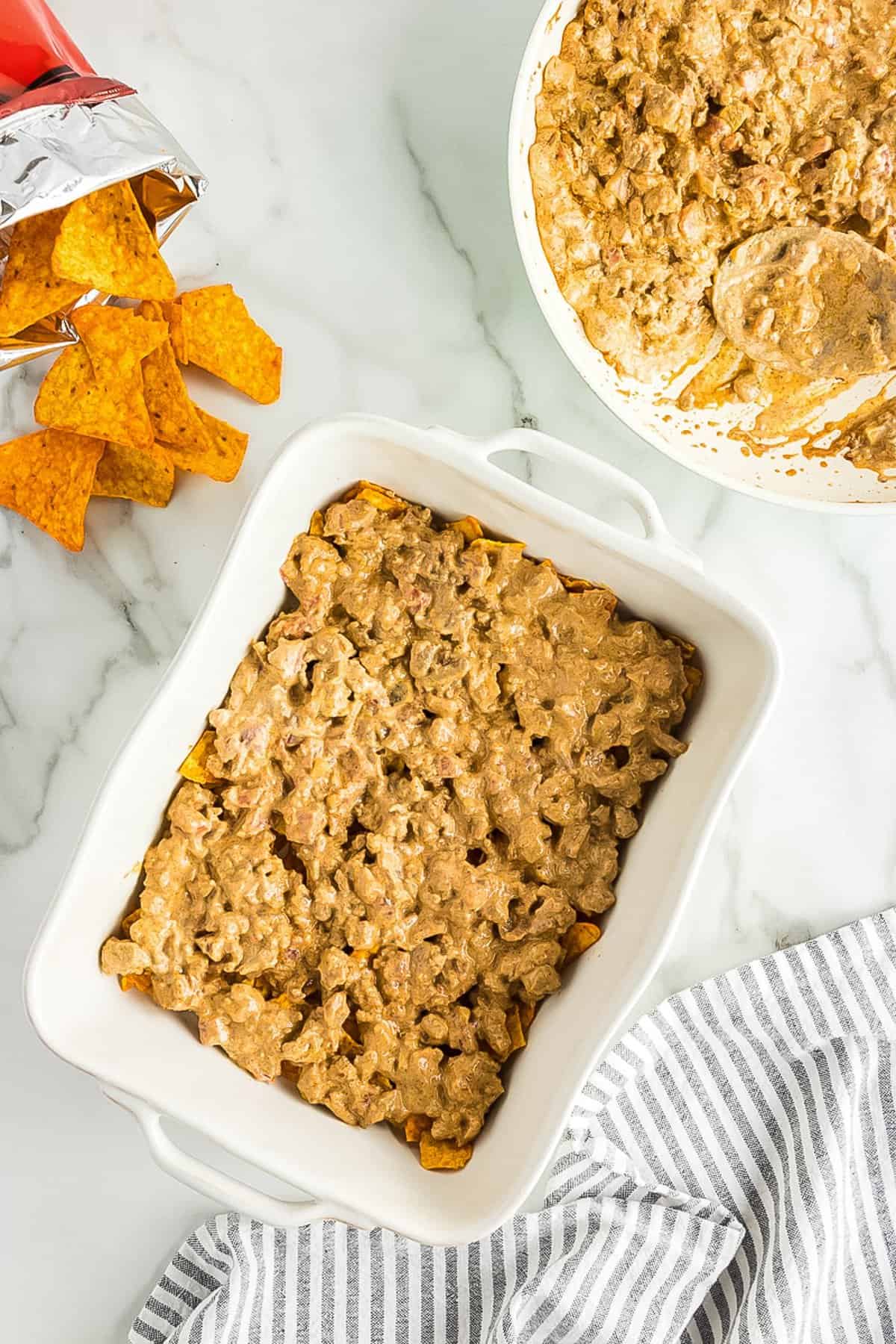 Dorito casserole filling in casserole dish