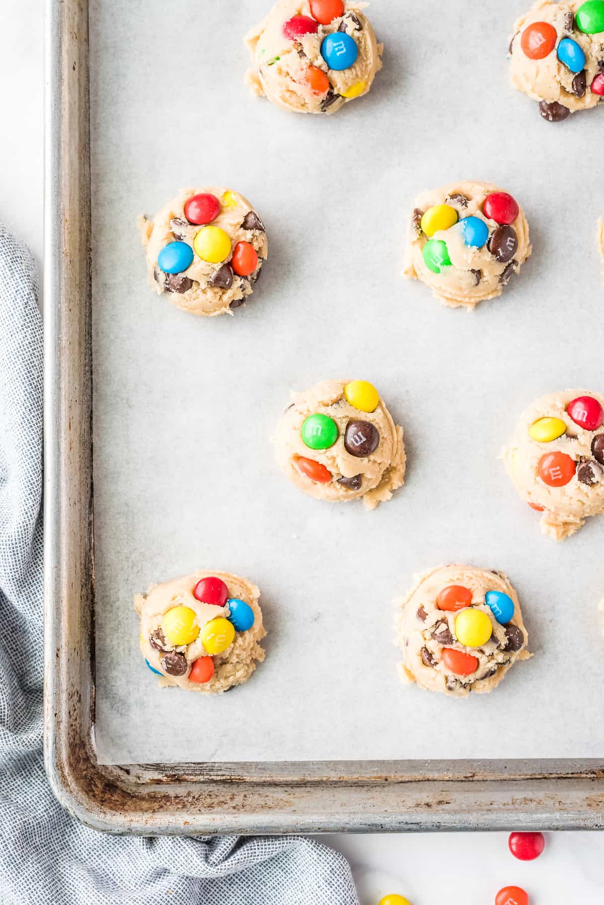 Overhead Image of raw M&M cookies on baking sheet