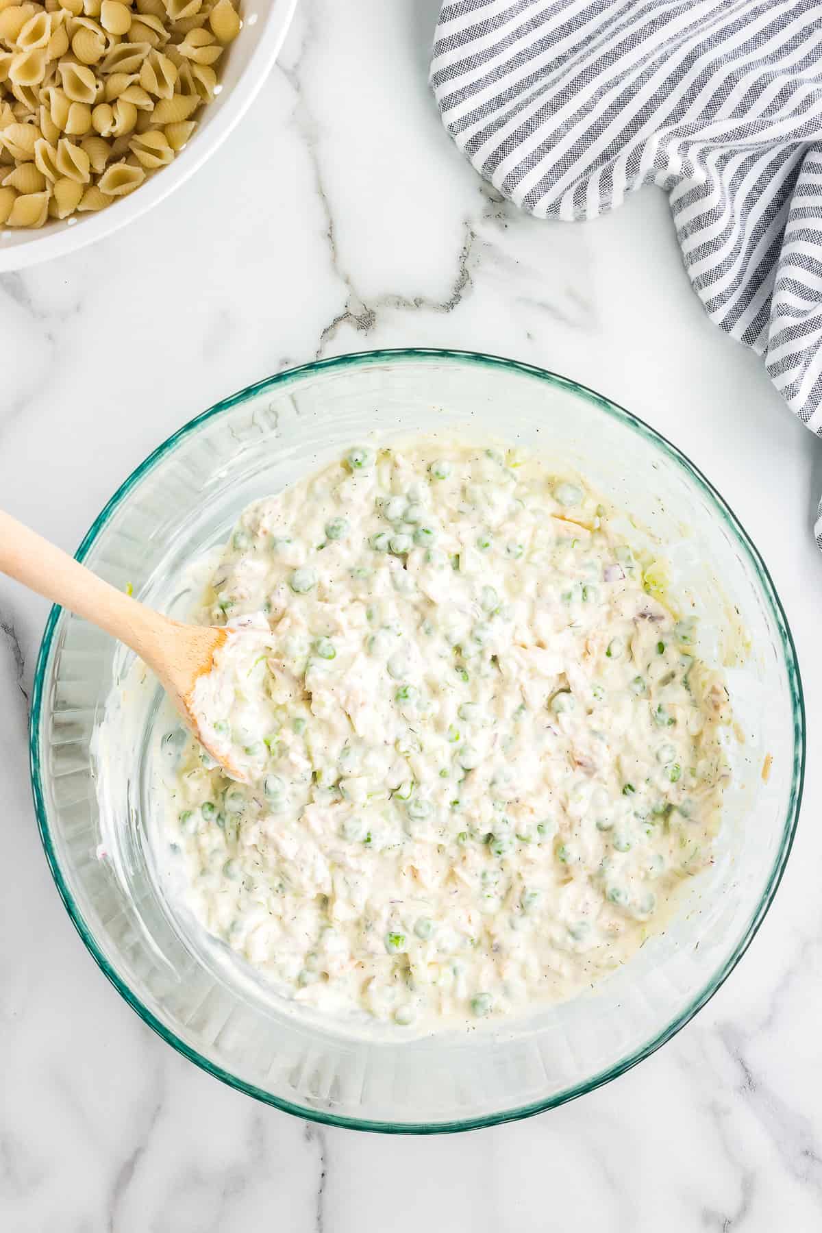 Mixing ingredient in bowl for pasta salad