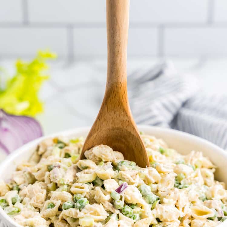 Wooden spoon in bowl of Tuna Pasta Salad