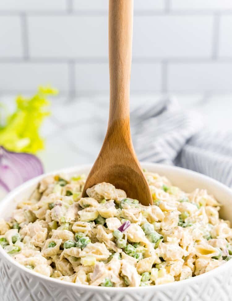 Wooden spoon in bowl of Tuna Pasta Salad