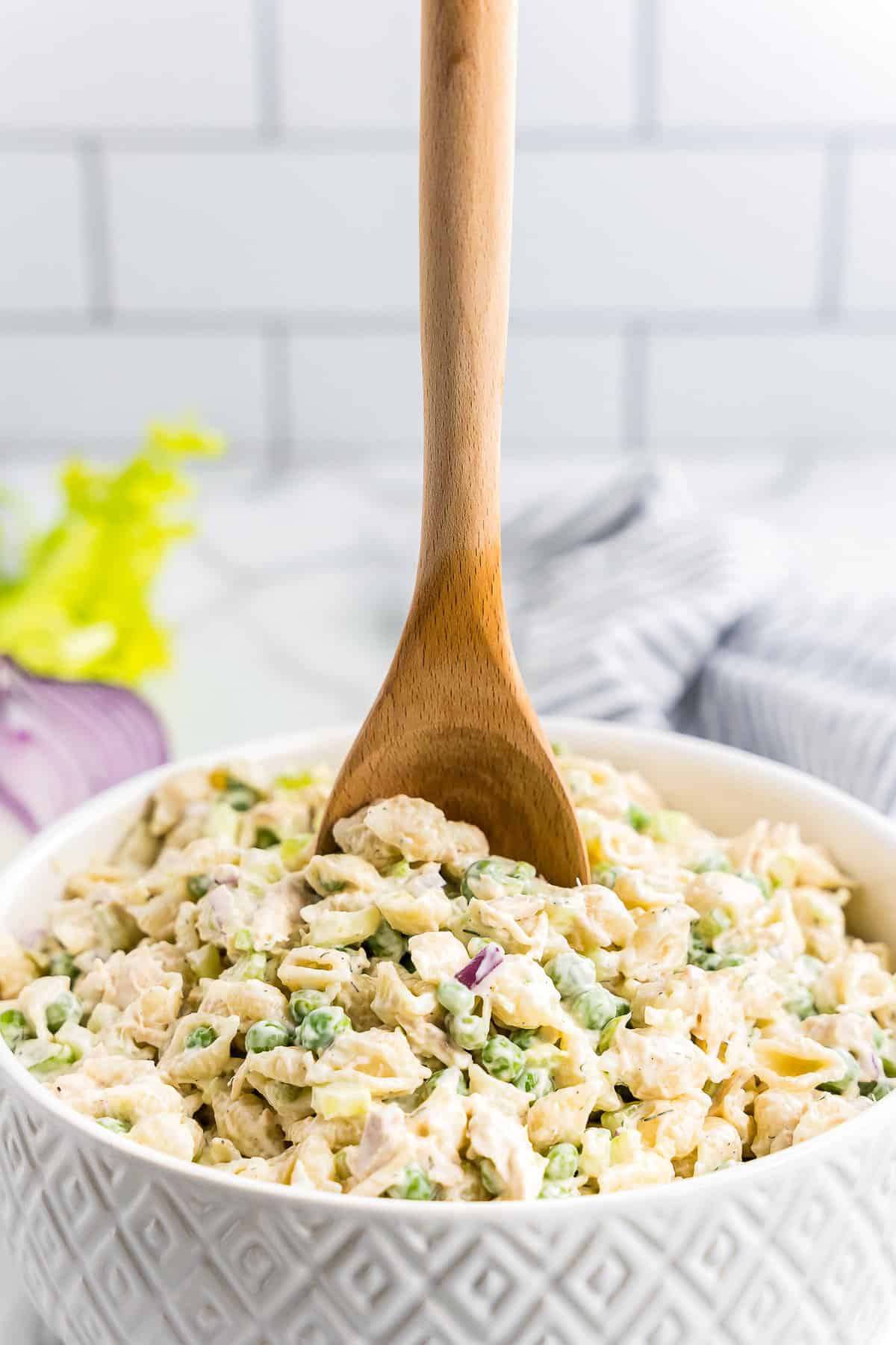 Wooden spoon in bowl of Tuna Pasta Salad