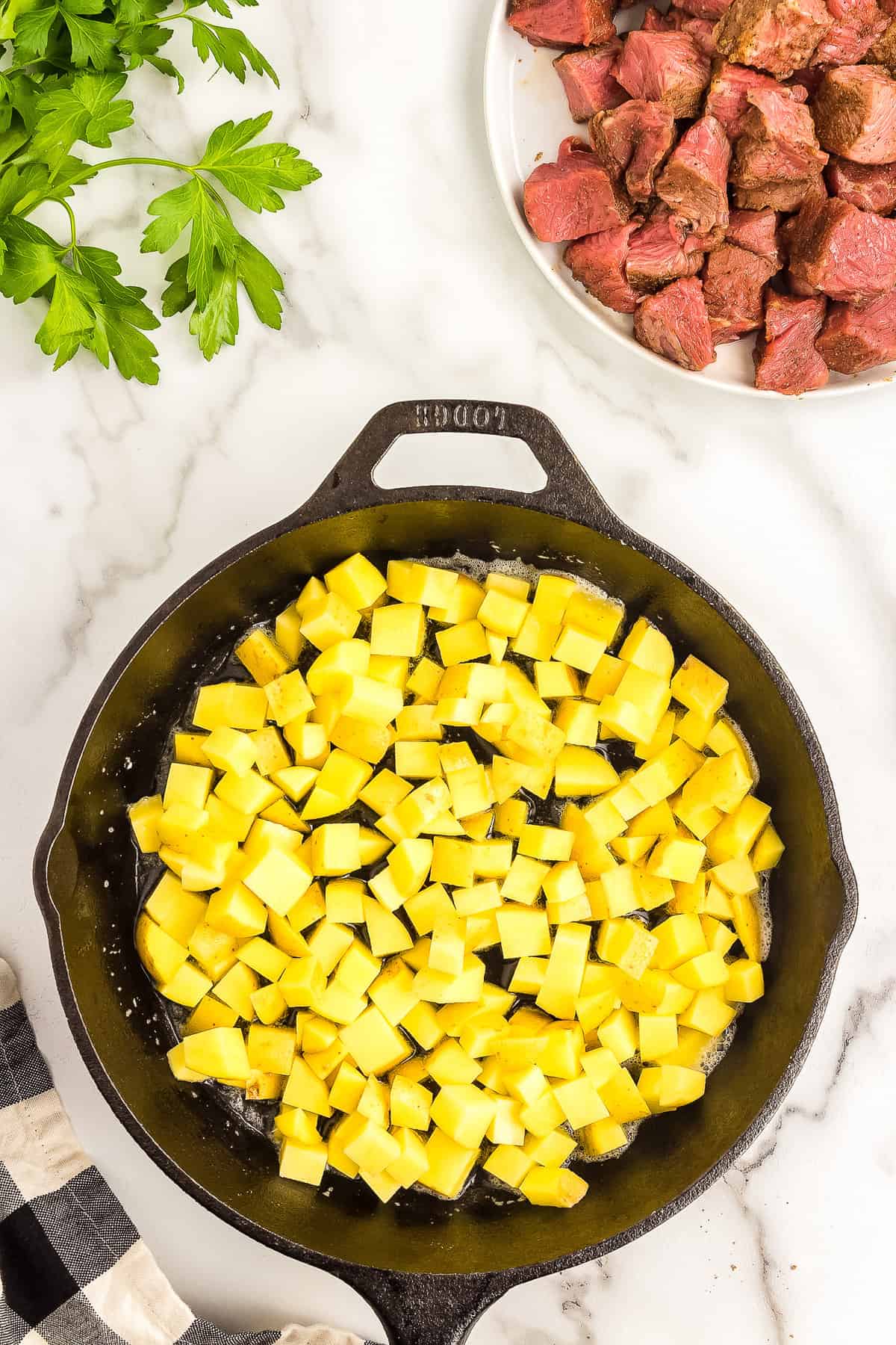 Cast iron pan with small potato pieces