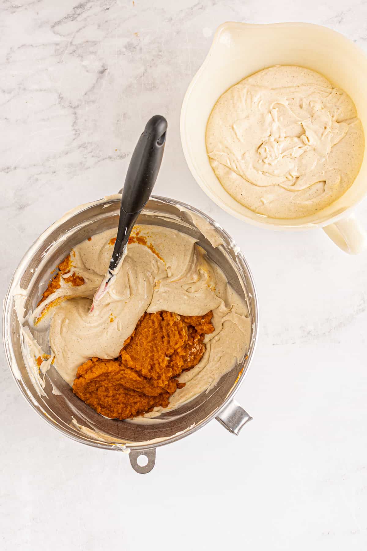 Pumpkin in cheesecake filling in mixing bowl