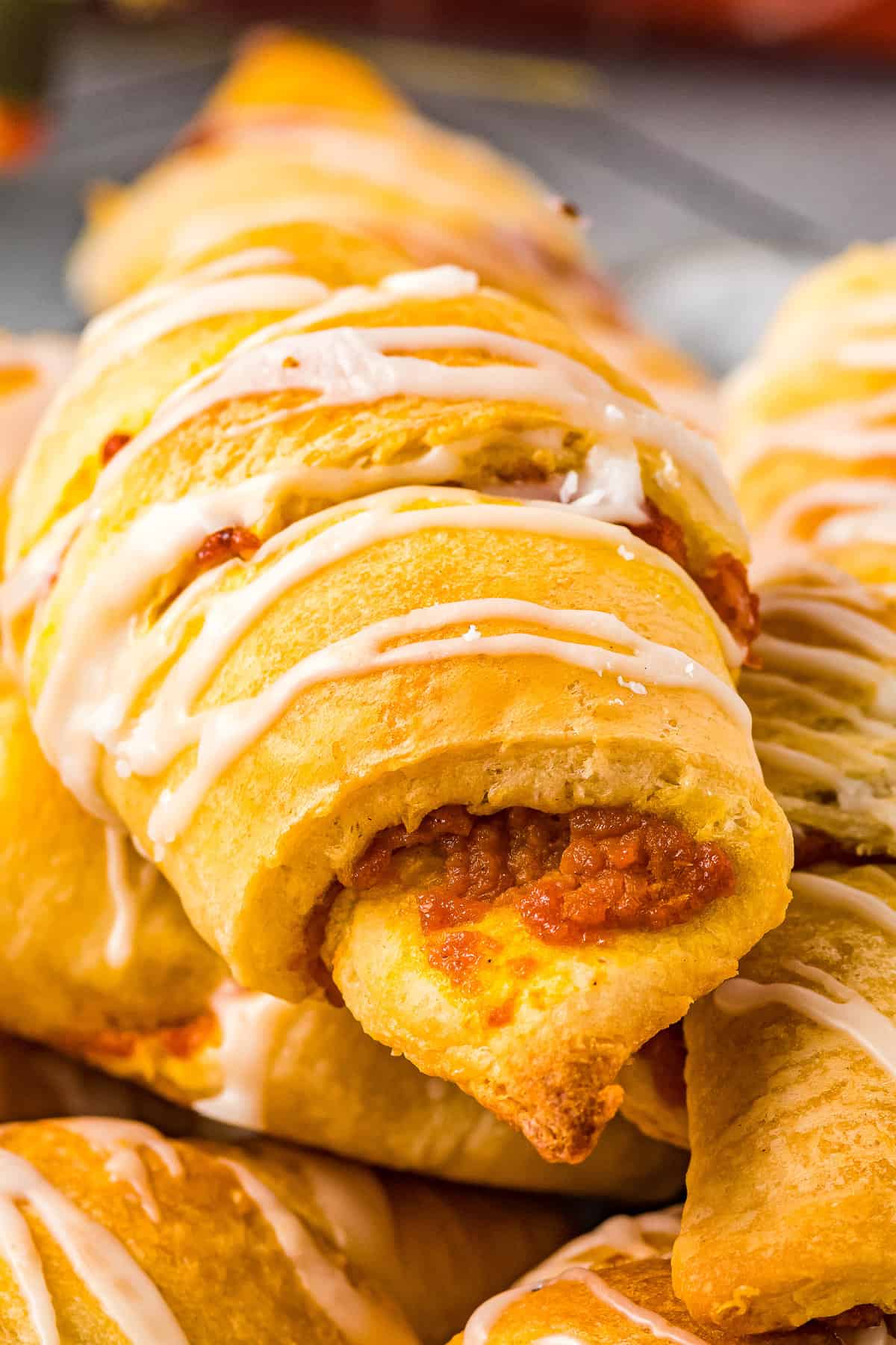 Close up of pumpkin crescent roll with glaze