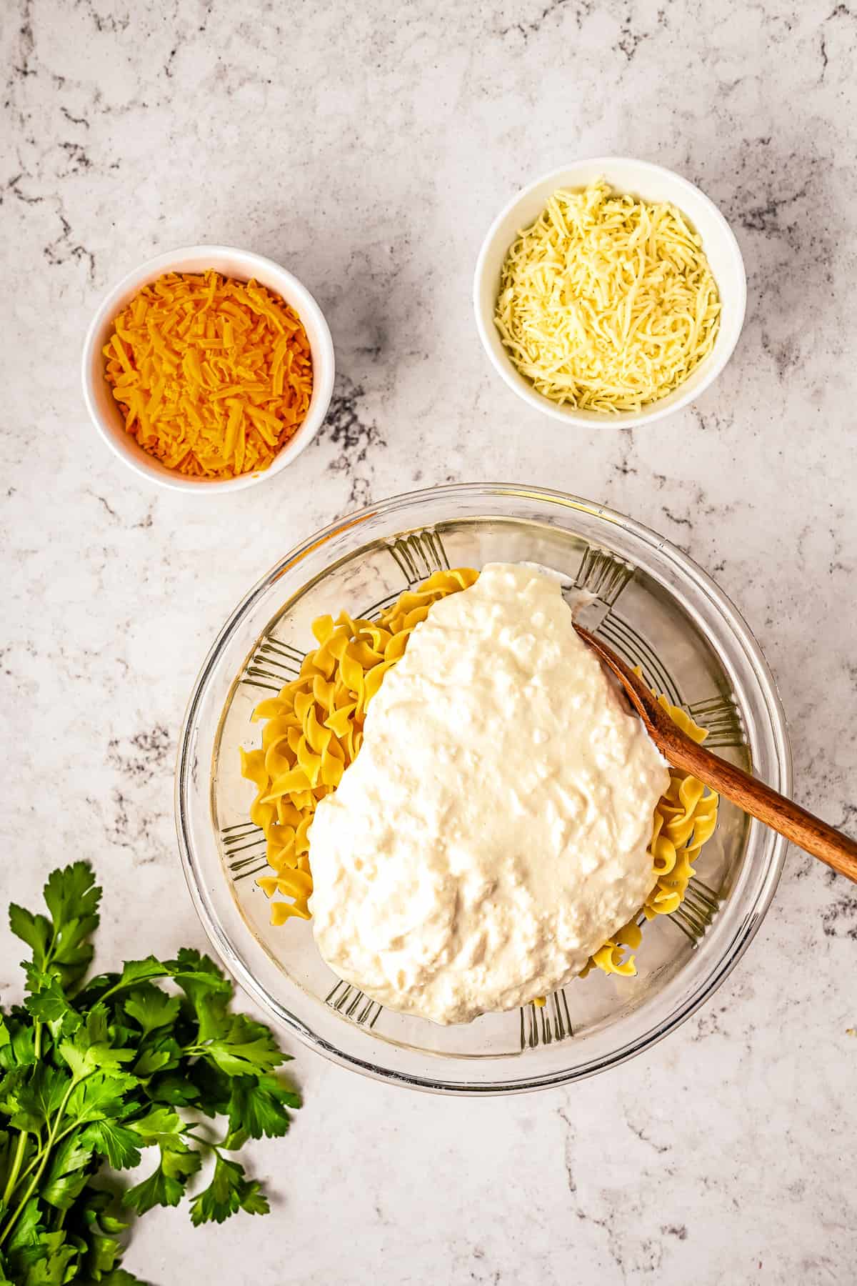 Glass bowl with egg noodles and cheese sauce