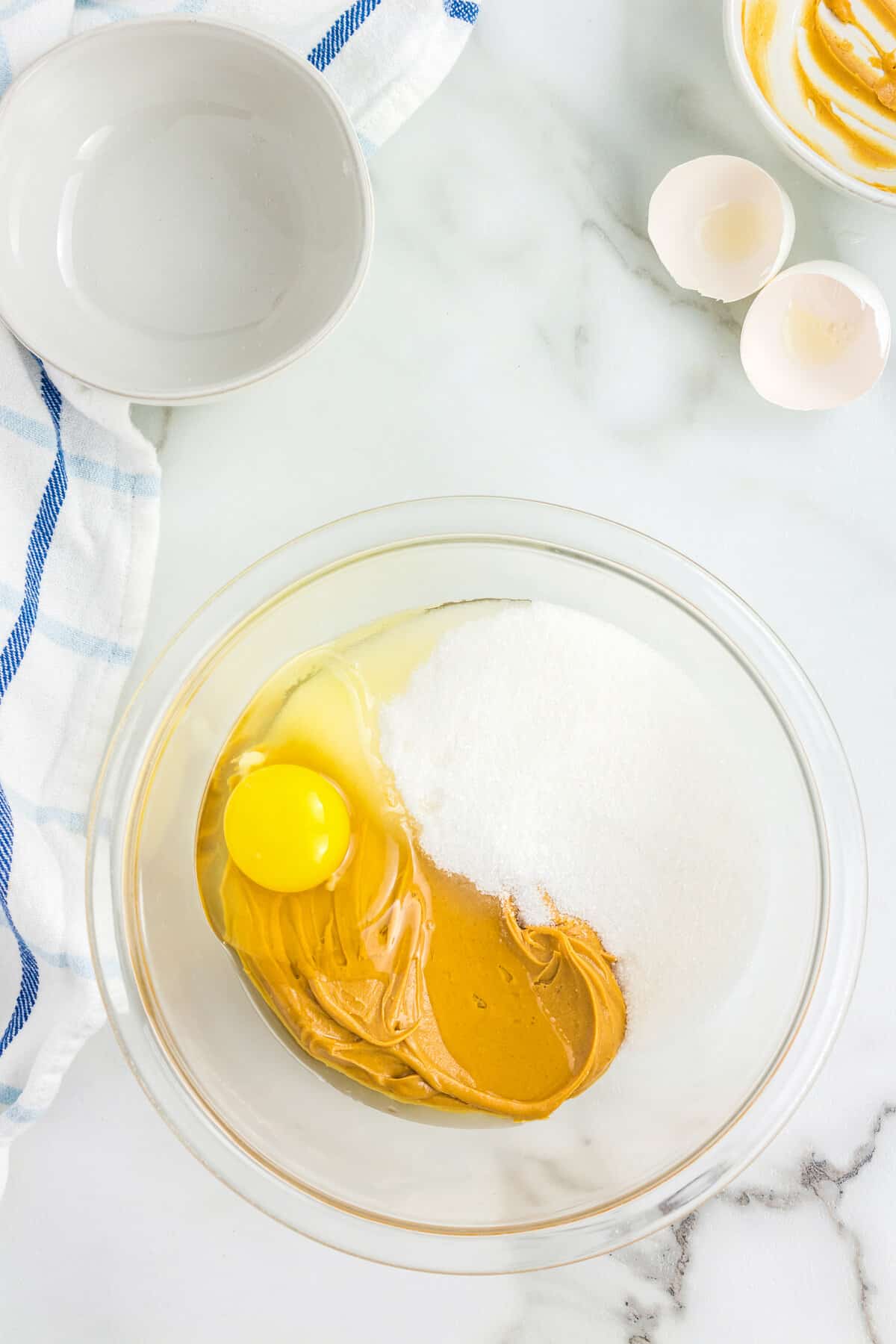 Glass bowl with sugar, egg and peanut butter
